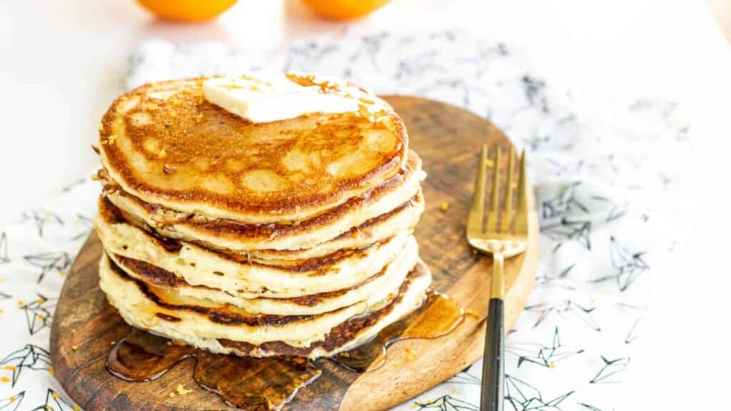 Orange Ricotta Pancakes on a wooden board.