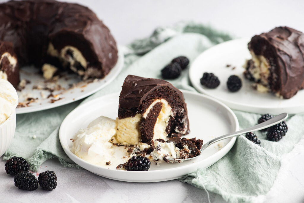 An image of a slice of Chocolate Mocha Bundt Cake with Cheesecake Filling on a white plate.