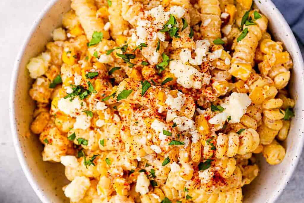 A close up image of Street Corn Pasta Salad in a white bowl.