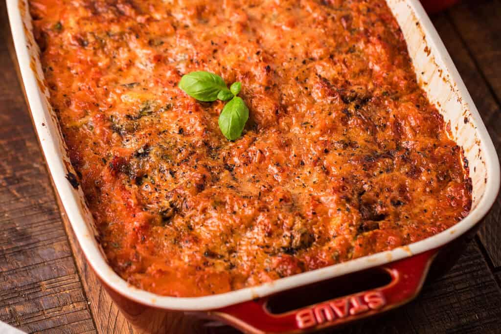 A pan of Italian Eggplant Parmigiana with Vodka Sauce topped with fresh basil