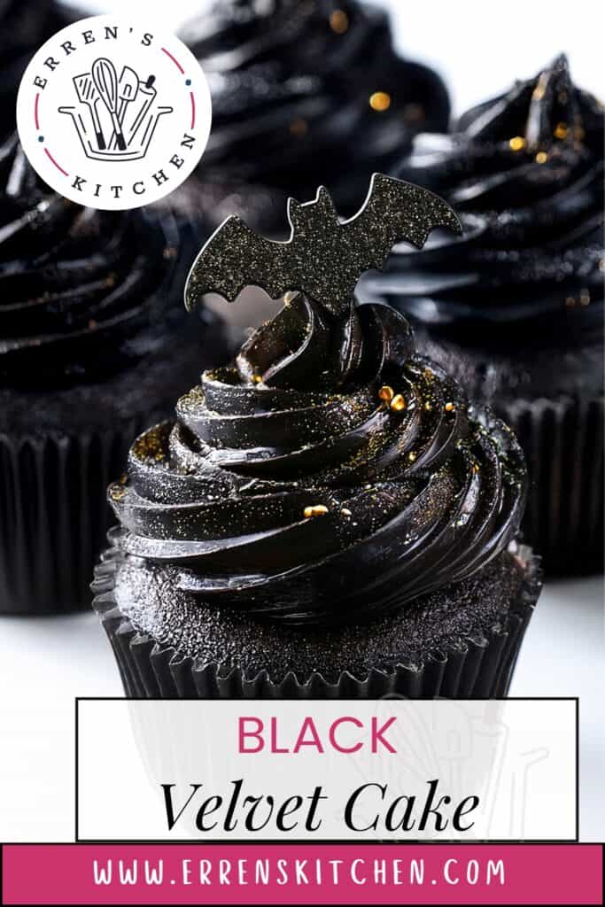 A close-up of Black Velvet Cake cupcakes with sparkling black frosting, each topped with a glittery bat decoration. The image features a logo of a kitchen utensil set, alongside text reading "Black Velvet Cake", and "www.errenskitchen.com" elegantly displayed at the bottom.