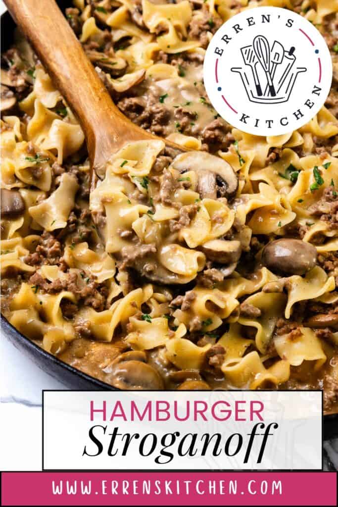 A skillet brimming with creamy hamburger stroganoff, featuring savory ground beef, mushrooms, and tender egg noodles, garnished with fresh parsley. A wooden spoon elegantly scoops a portion of this delicious dish. The image is proudly branded from Erren's Kitchen.