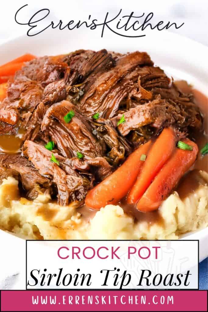 A plate of crock pot sirloin tip roast, a delightful roast recipe, served on mashed potatoes with cooked carrots and garnished with herbs. The image beautifully displays the dish from Erren's Kitchen.