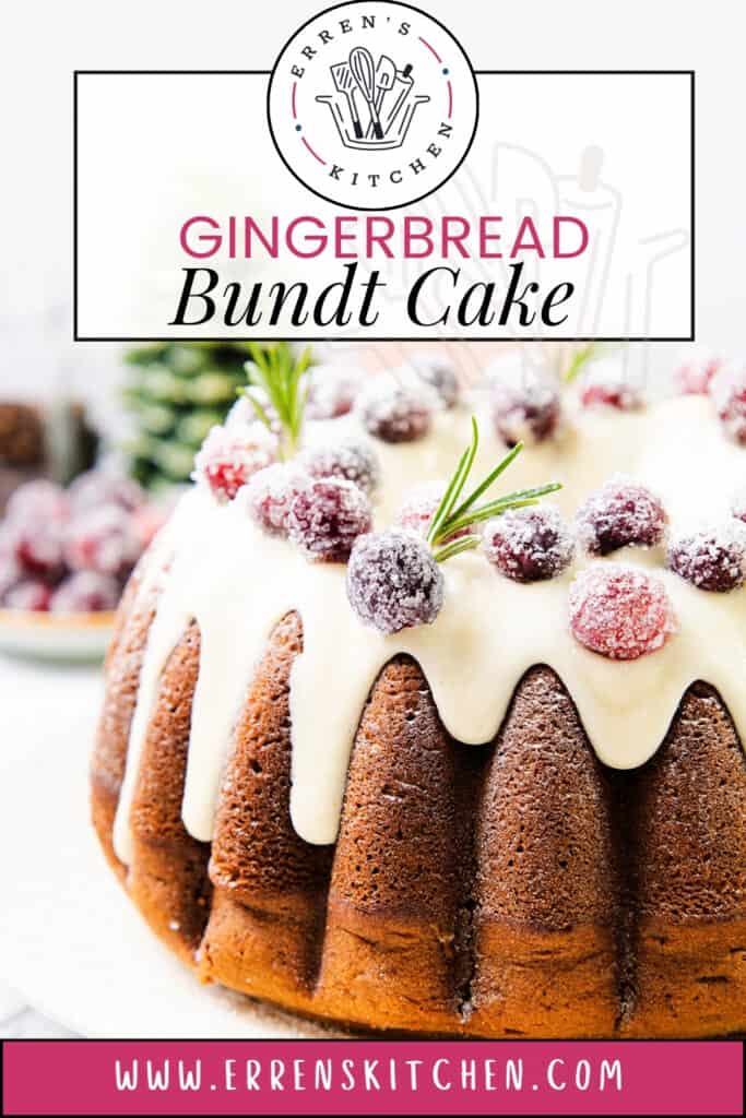 A delightful gingerbread Bundt cake is elegantly topped with white icing, sugared cranberries, and rosemary sprigs. Set on a pristine white surface, this creation from Erren's Kitchen exudes charm and flavor in every slice.