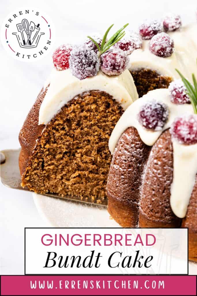 A slice of scrumptious gingerbread bundt cake with white icing and sugared cranberries is partially removed. The cake graces a white surface adorned with rosemary sprigs. Branding and website info are elegantly displayed on the image.