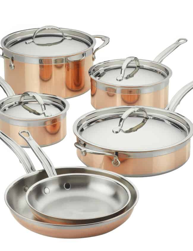 Discover the Hestan CopperBond Cookware, a stunning set of copper and stainless steel pots and pans with silver handles. Featuring five versatile saucepans and frying pans with lids, all neatly arranged against a white background—get it now for the best time in your kitchen!