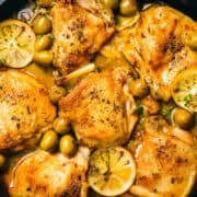 A skillet filled with golden-brown chicken thighs, green olives, and lemon slices in a savory sauce makes for one of the most popular recipes. The dish is a delight, garnished with herbs and cooked to a crispy texture.