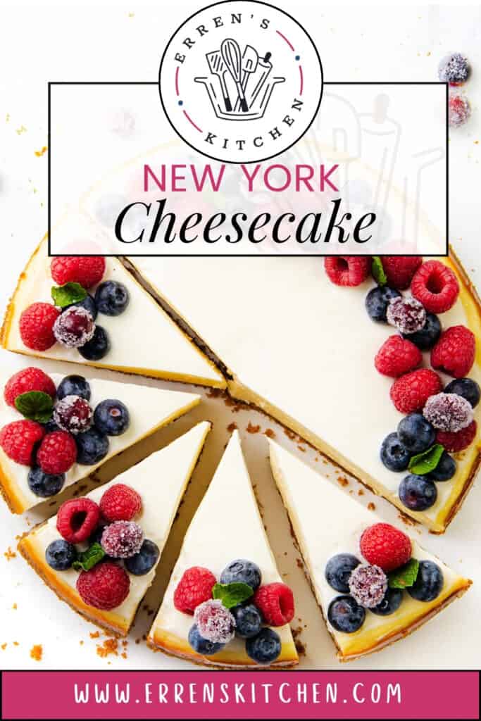 Top view of a classic New York cheesecake adorned with fresh raspberries, blueberries, and red currants. The sliced cake reveals its creamy filling and golden crust. Erren's Kitchen logo and website URL grace the top and bottom.