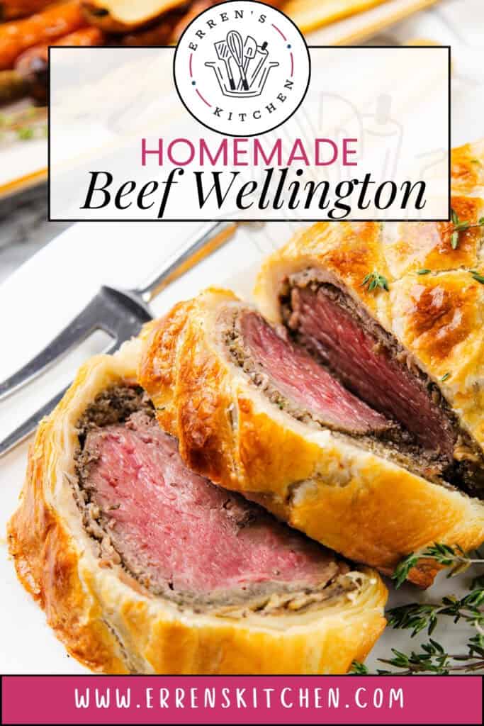 A sliced Beef Wellington with golden pastry and tender pink beef, garnished with thyme. A fork lies beside the dish, adding a touch of elegance. The image features text: "Homemade Beef Wellington" and directs to the website link "www.errenskitchen.com.