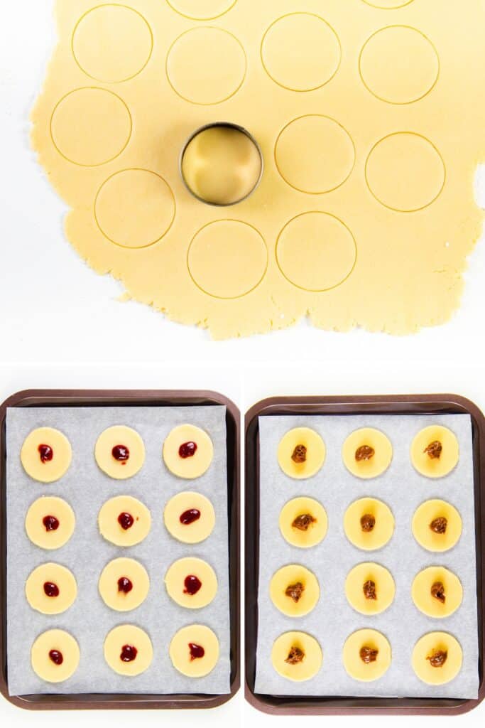 Round cookie dough shapes are cut out from rolled-out dough. Below, two baking trays hold Italian pinch cookies, each topped with a small dollop of jam. The cookies are arranged on parchment paper, ready to be baked.