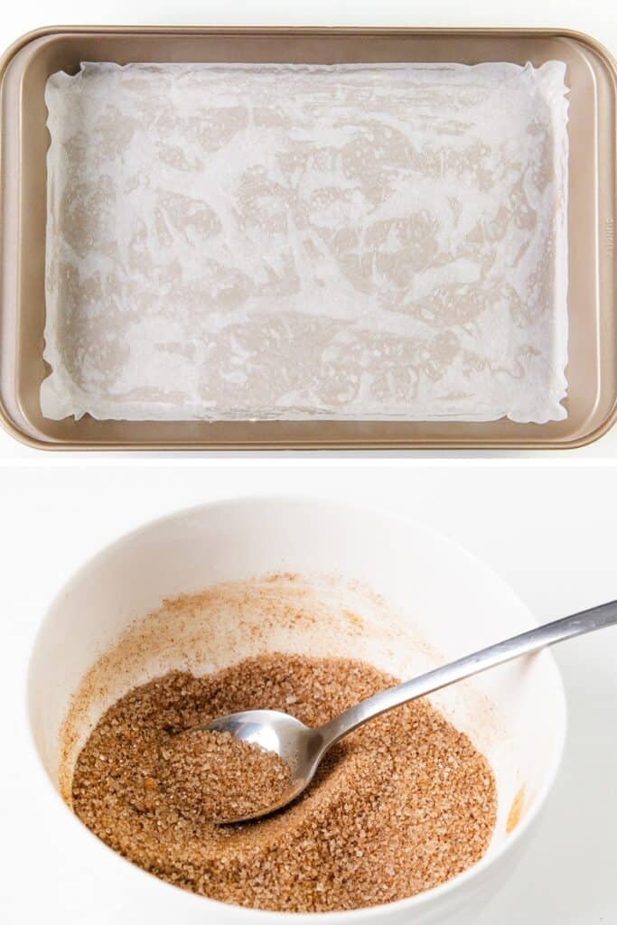 A baking sheet lined with parchment paper is shown above a bowl filled with the cinnamon and sugar mixture used for Snickerdoodle bars, with a spoon resting inside the bowl.