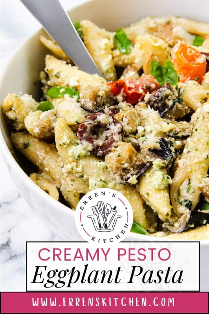 A bowl of creamy ricotta pesto eggplant pasta is garnished with cherry tomatoes, olives, mushrooms, and cheese. The dish is elegantly presented in a white bowl with a label from Erren's Kitchen and the website errenskitchen.com.