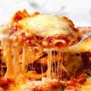 Italian Sausage Ravioli Casserole being lifted from the pan with a spoon