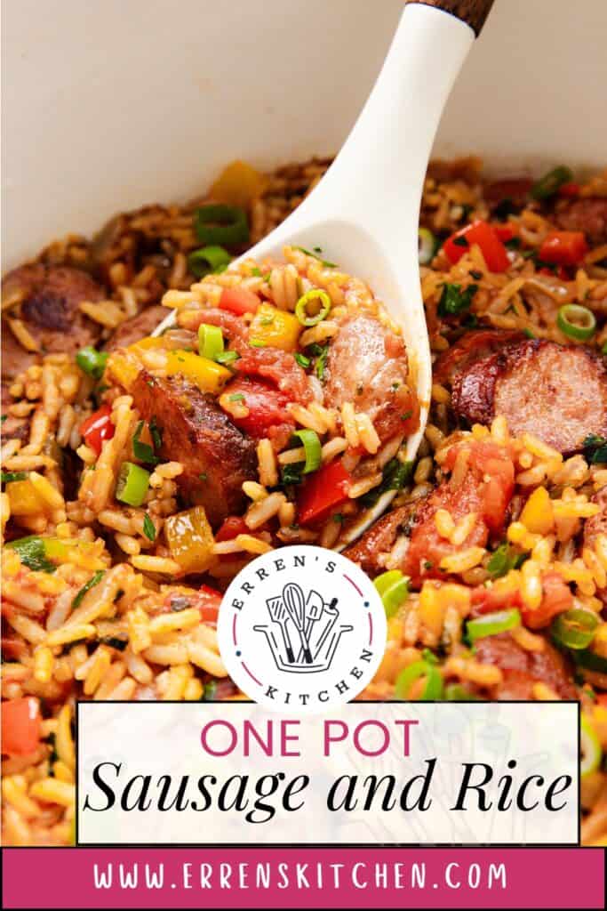 Close-up of One Pot Sausage and Rice in a pot. A spoon holds a portion showcasing its hearty mix of sausage slices, rice, diced tomatoes, and chopped green onions. This comforting recipe is courtesy of Erren's Kitchen; find more delicious details on their website.