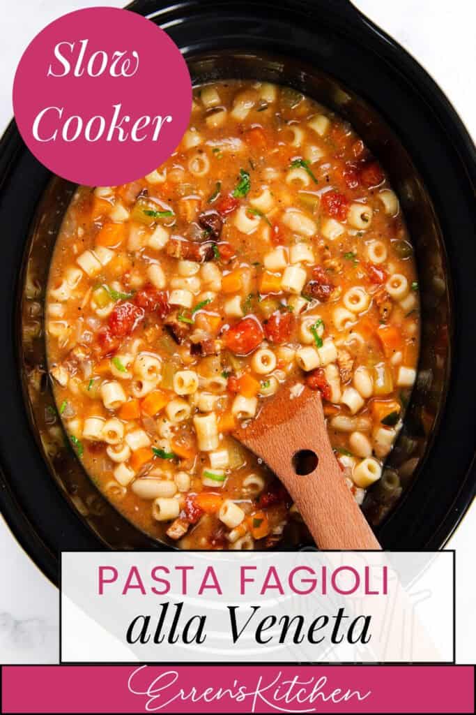 A slow cooker filled with Pasta Fagioli alla Veneta, showcasing small pasta, beans, and tomatoes in a savory broth. A wooden spoon rests inside. A pink circle in the corner reads "Slow Cooker" while "Authentic Italian Recipe" is elegantly labeled below.