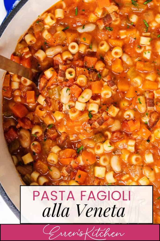 A close-up of a pot filled with Pasta Fagioli alla Veneta, showcasing a rich tomato-based soup with pasta, beans, carrots, and herbs. A ladle rests in the pot. The text "Pasta Fagioli alla Veneta, Erren's Kitchen" elegantly adorns the image.