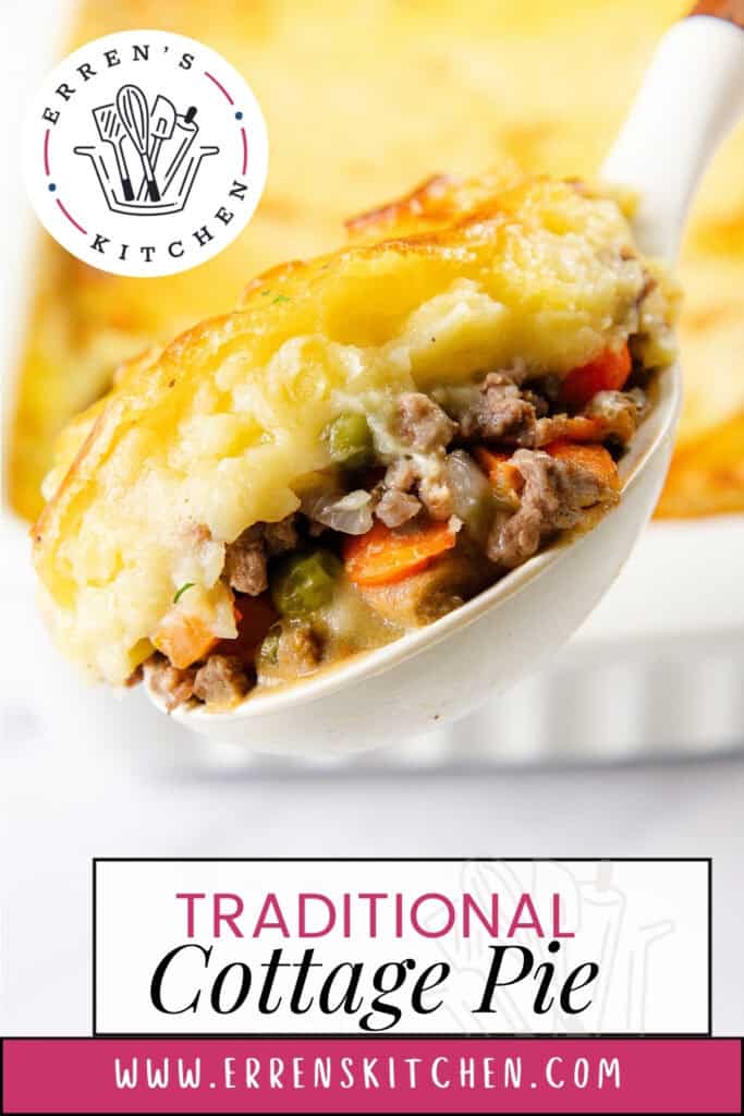 A spoonful of classic Traditional Cottage Pie showcases savory minced meat, peas, and carrots crowned with fluffy mashed potatoes. In the background, the rest of the delicious pie sits invitingly in a baking dish. Text on image: "Traditional Cottage Pie" and "www.errenskitchen.com".